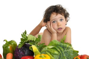 Foto de un niño rodeado de verduras